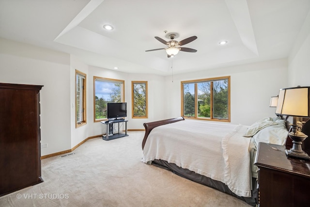 bedroom featuring a raised ceiling, baseboards, carpet floors, recessed lighting, and ceiling fan