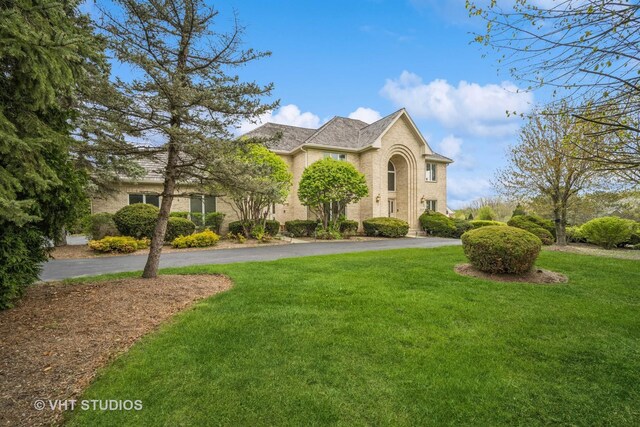 6245 Pine Tree Dr, Long Grove, IL 60047 - traditional home with a front yard, asphalt driveway, and brick siding