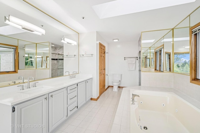 full bath with a skylight, a shower stall, a tub with jets, double vanity, and toilet