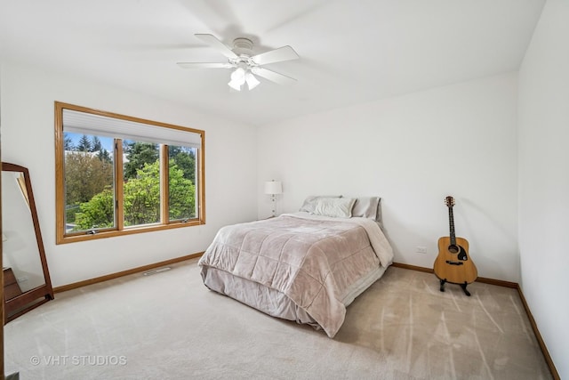 bedroom with baseboards, light carpet, and ceiling fan