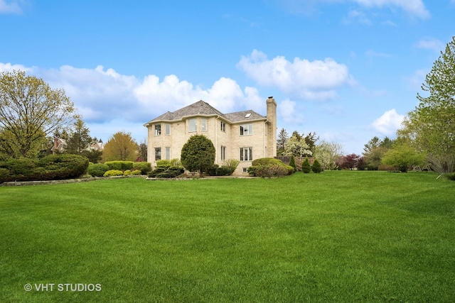 view of front of property featuring a chimney and a front yard