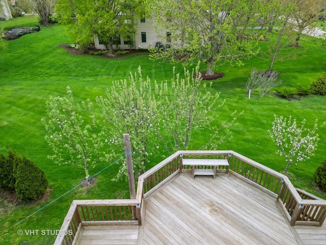 wooden deck featuring a yard