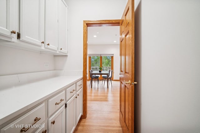 hall featuring light wood-style floors and recessed lighting