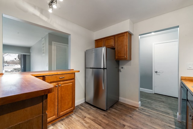 5300 Carriageway Dr Unit 102, Rolling Meadows, IL 60008 - kitchen featuring freestanding refrigerator, brown cabinetry, baseboards, and wood finished floors