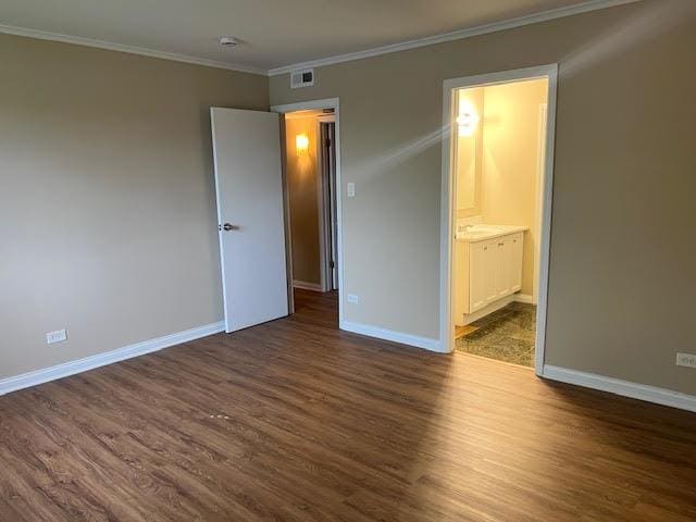 18063 Live Oak Ct Unit 1608, Tinley Park, IL 60477 - unfurnished bedroom featuring dark wood-style floors, baseboards, ornamental molding, and ensuite bath