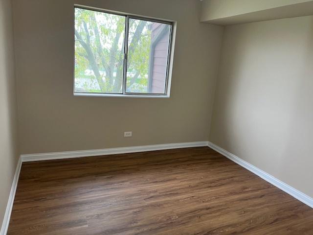 18063 Live Oak Ct Unit 1608, Tinley Park, IL 60477 - spare room with plenty of natural light, dark wood-type flooring, and baseboards