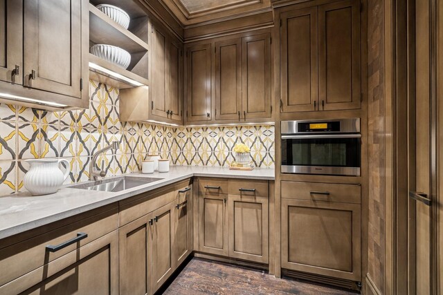 77 E Walton St Unit 25C, Chicago, IL 60611 - kitchen featuring stainless steel oven, decorative backsplash, open shelves, and light stone countertops
