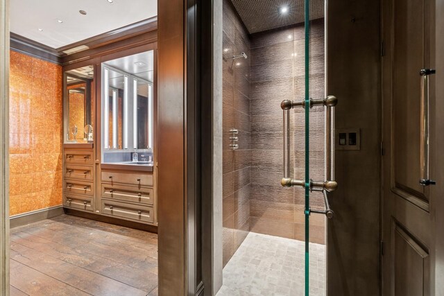 77 E Walton St Unit 25C, Chicago, IL 60611 - full bath featuring a tile shower, hardwood / wood-style floors, and vanity