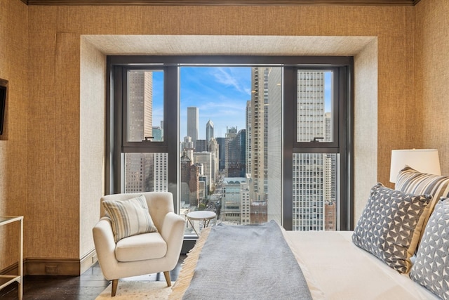 77 E Walton St Unit 25C, Chicago, IL 60611 - bedroom featuring wood finished floors, multiple windows, wallpapered walls, and a view of skyline