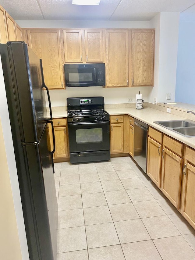 656 Pearson St Unit 608C, Des Plaines, IL 60016 - kitchen with black appliances, light tile patterned floors, a sink, and light countertops