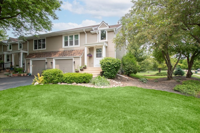 300 Hunters Cir, Fox River Grove, IL 60021 - view of front of house featuring a garage, driveway, and a front lawn