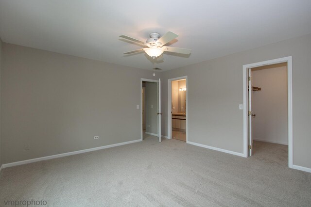 300 Hunters Cir, Fox River Grove, IL 60021 - unfurnished bedroom featuring light carpet, a spacious closet, baseboards, ensuite bathroom, and a ceiling fan