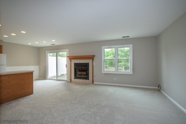300 Hunters Cir, Fox River Grove, IL 60021 - unfurnished living room with light colored carpet, a tiled fireplace, recessed lighting, and baseboards