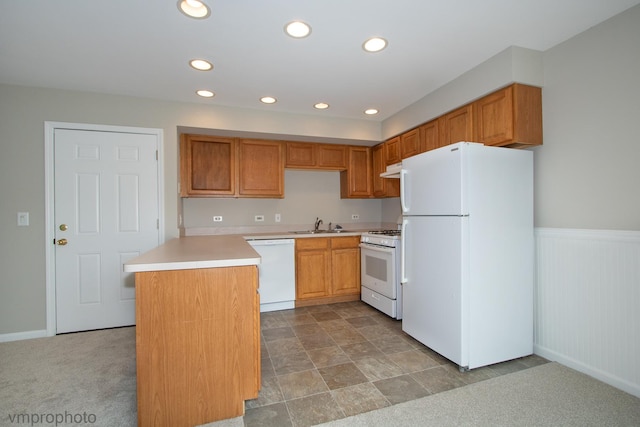 300 Hunters Cir, Fox River Grove, IL 60021 - kitchen with white appliances, light countertops, under cabinet range hood, recessed lighting, and a wainscoted wall