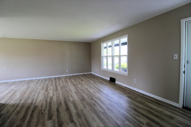 unfurnished room featuring wood finished floors and baseboards