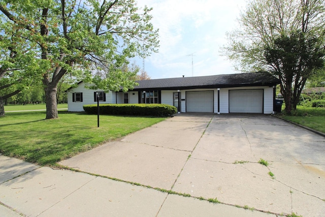 single story home featuring an attached garage, a front yard, and driveway