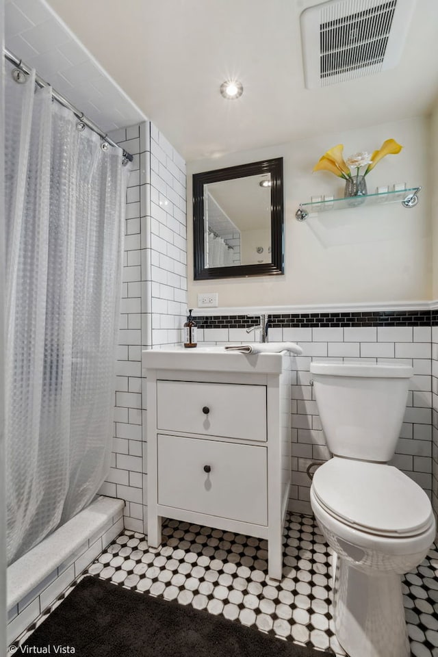 8139 W Bryn Mawr Ave, Norwood Park, IL 60631 - bathroom featuring tile walls, toilet, a shower with curtain, vanity, and tile patterned floors