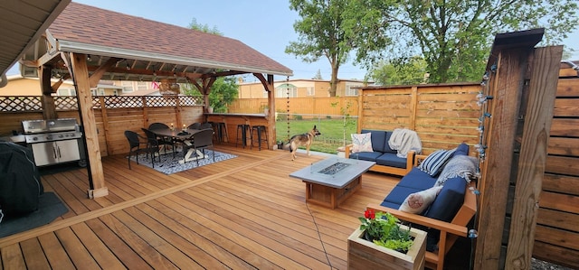 8139 W Bryn Mawr Ave, Norwood Park, IL 60631 - deck with an outdoor living space with a fire pit, outdoor dining area, a grill, and a fenced backyard