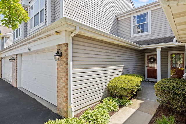 1992 Town Dr, Naperville, IL 60565 - entrance to property featuring a garage, brick siding, and a shingled roof