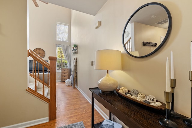 1992 Town Dr, Naperville, IL 60565 - hall with stairs, baseboards, wood finished floors, and a towering ceiling