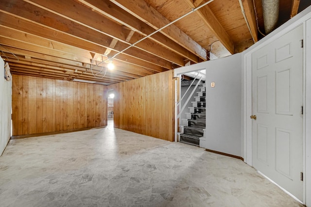finished below grade area with stairway and wood walls