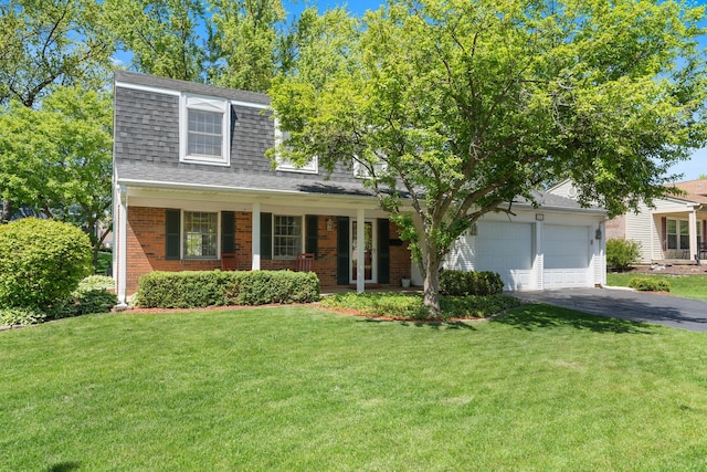 1712 Sutton Ln, Schaumburg, IL 60194 - view of front of house with driveway, a shingled roof, an attached garage, brick siding, and a front lawn