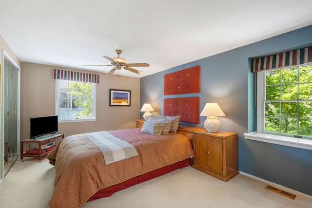1712 Sutton Ln, Schaumburg, IL 60194 - bedroom with light carpet, ceiling fan, and baseboards