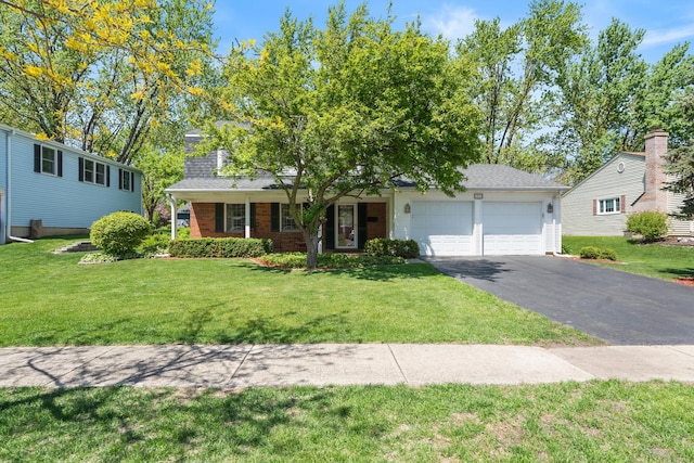 1712 Sutton Ln, Schaumburg, IL 60194 - view of front facade with a garage, asphalt driveway, a front lawn, and a shingled roof