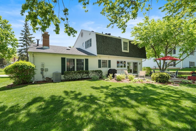 1712 Sutton Ln, Schaumburg, IL 60194 - back of property featuring a shingled roof, a chimney, a lawn, and a patio area
