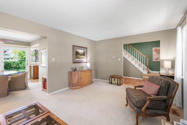 1712 Sutton Ln, Schaumburg, IL 60194 - living area with plenty of natural light, stairway, baseboards, and light carpet
