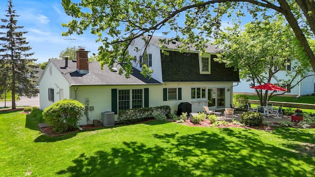 1712 Sutton Ln, Schaumburg, IL 60194 - back of property featuring a patio area, a yard, a shingled roof, and central AC