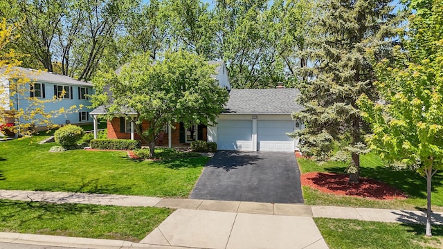 1712 Sutton Ln, Schaumburg, IL 60194 - view of front facade with an attached garage, asphalt driveway, a front yard, and roof with shingles