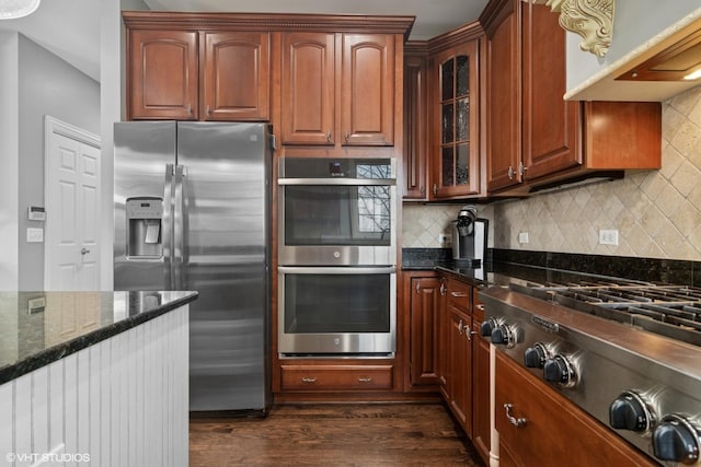 101 Lucy Ct, Lake Zurich, IL 60047 - kitchen with stainless steel appliances, dark wood-type flooring, dark stone countertops, glass insert cabinets, and decorative backsplash