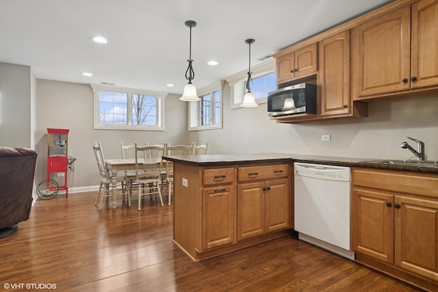 101 Lucy Ct, Lake Zurich, IL 60047 - kitchen with dishwasher, stainless steel microwave, a sink, a peninsula, and dark wood-type flooring