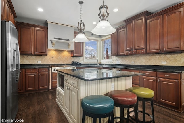 101 Lucy Ct, Lake Zurich, IL 60047 - kitchen featuring appliances with stainless steel finishes, dark wood-style flooring, a kitchen bar, recessed lighting, and backsplash