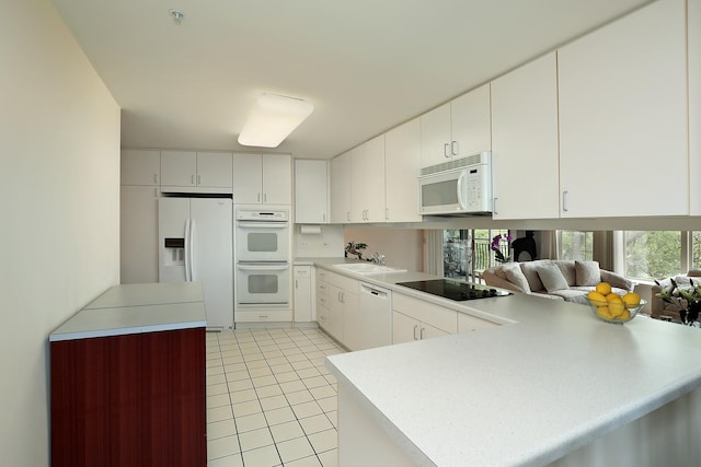1625 Glenview Rd Unit 210, Glenview, IL 60025 - kitchen featuring white appliances, a peninsula, light tile patterned floors, light countertops, and a sink