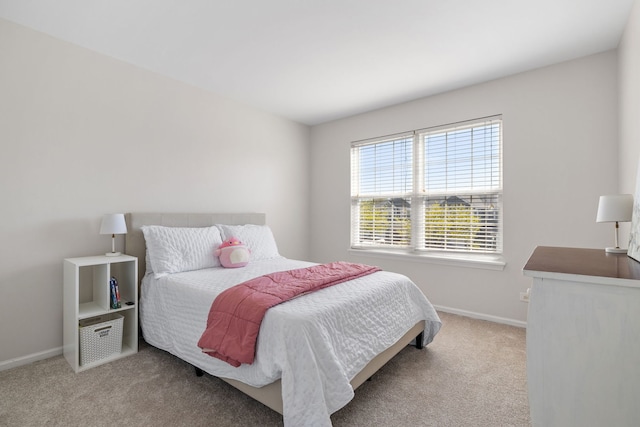 carpeted bedroom featuring baseboards