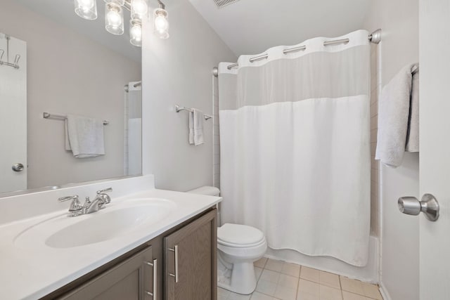 full bath with toilet, tile patterned floors, vanity, and shower / bath combo