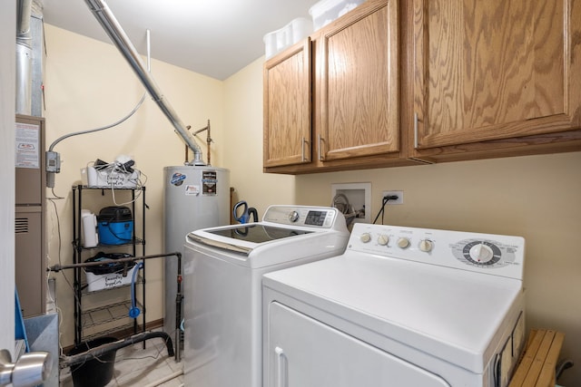 laundry area featuring cabinet space, washer and clothes dryer, and water heater