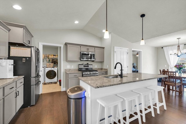 3901 Obsidian Dr, Champaign, IL 61822 - kitchen with appliances with stainless steel finishes, a sink, gray cabinets, lofted ceiling, and a kitchen breakfast bar