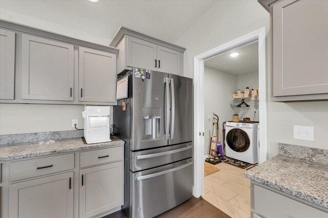 3901 Obsidian Dr, Champaign, IL 61822 - kitchen featuring stainless steel fridge, gray cabinets, washer and clothes dryer, and light stone counters