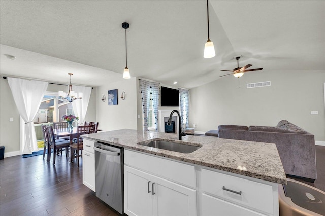 3901 Obsidian Dr, Champaign, IL 61822 - kitchen with stainless steel dishwasher, a sink, vaulted ceiling, light stone counters, and ceiling fan