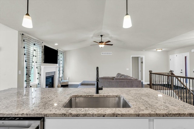 3901 Obsidian Dr, Champaign, IL 61822 - kitchen with a sink, open floor plan, a ceiling fan, stainless steel dishwasher, and light stone counters