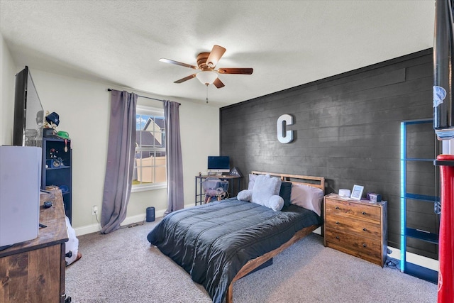 3901 Obsidian Dr, Champaign, IL 61822 - carpeted bedroom featuring an accent wall, baseboards, a ceiling fan, and a textured ceiling
