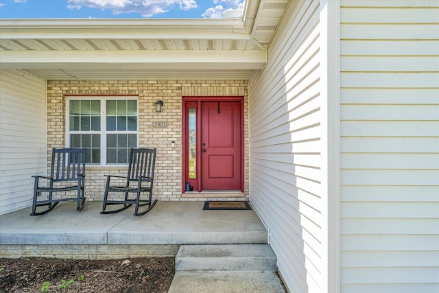 3901 Obsidian Dr, Champaign, IL 61822 - view of exterior entry with a porch and brick siding