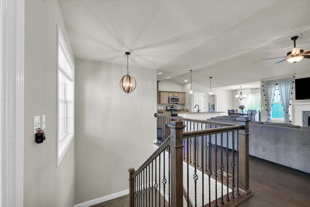 3901 Obsidian Dr, Champaign, IL 61822 - stairs featuring a chandelier, ceiling fan, wood finished floors, baseboards, and vaulted ceiling