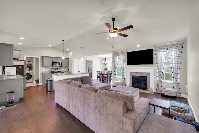 3901 Obsidian Dr, Champaign, IL 61822 - living room featuring lofted ceiling, ceiling fan, dark wood-type flooring, washer / dryer, and a glass covered fireplace