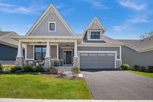 1553 Dempsey Dr, Saint Charles, IL 60174 - craftsman house featuring board and batten siding, stone siding, driveway, covered porch, and a front yard