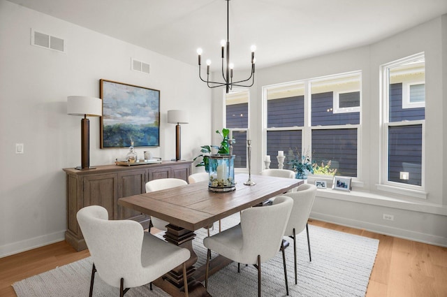 1553 Dempsey Dr, Saint Charles, IL 60174 - dining area featuring a chandelier, baseboards, and light wood-style flooring