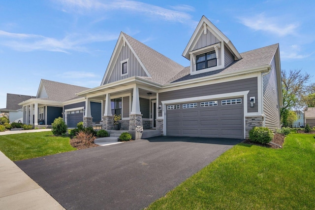 1553 Dempsey Dr, Saint Charles, IL 60174 - craftsman house featuring stone siding, a porch, driveway, a front yard, and board and batten siding
